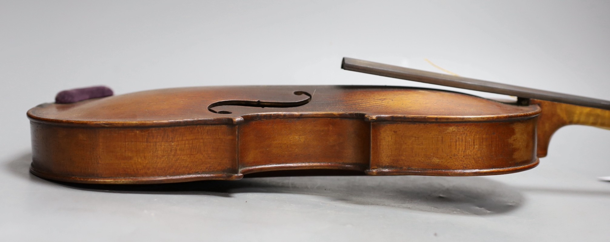 A cased 19th century violin, labelled Stradivarius 1690, with a Dodd bow